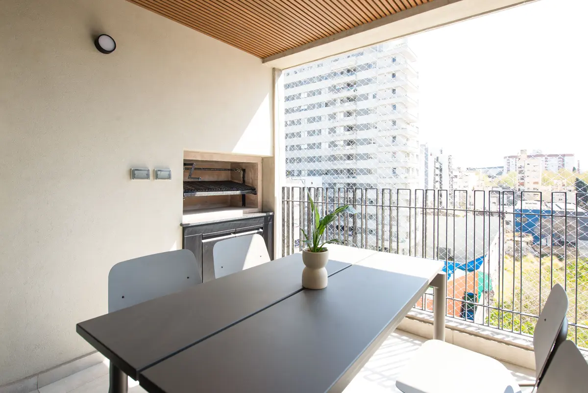 terraço moderno com churrasqueira e mesa externa urbana — projeto LOT Serrano, por C - ESTUDIO, em Buenos Aires